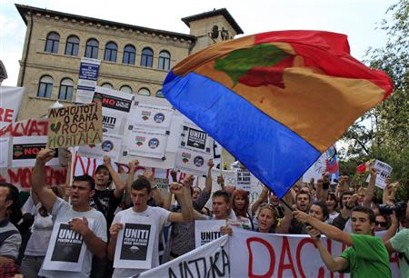 Protesters shout slogans during a demonstration against the opening of the Rosia Montana open cast gold mine in Bucharest September 1, 2013. REUTERS/Radu Sigheti