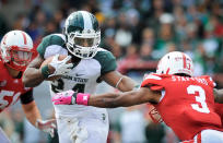 LINCOLN, NE - OCTOBER 29: Running back Le'Veon Bell #24 of the Michigan State Spartans stiff arm's safety Daimion Stafford #3 of the Nebraska Cornhuskers during their game at Memorial Stadium October 29, 2011 in Lincoln, Nebraska. Nebraska defeated Michigan State 24-3. (Photo by Eric Francis/Getty Images)