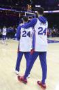 Philadelphia 76ers players warm up while wearing jerseys with Kobe Bryant's number on them, before an NBA basketball game against the Golden State Warriors on Tuesday, Jan. 28, 2020, in Philadelphia. Bryant died along with his daughter and seven other people during helicopter crash Sunday. (Steven M. Falk/The Philadelphia Inquirer via AP)