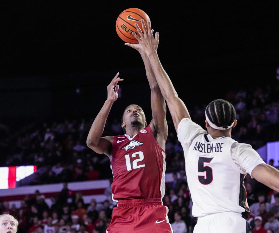 Jan 10, 2024; Athens, Georgia, USA; Arkansas Razorbacks guard Tramon Mark (12) shoots over Georgia Bulldogs center Frank Anselem-Ibe (5) at Stegeman Coliseum. Mandatory Credit: Dale Zanine-USA TODAY Sports