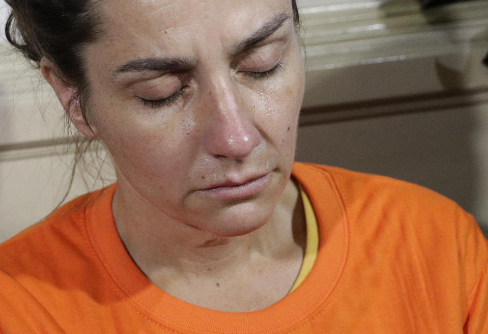 A tear rolls on the cheek of American national Jennifer Erin Talbot from Ohio before the start of a press conference by the National Bureau of Investigation (NBI) in Manila, Philippines, Thursday, Sept. 5, 2019. The NBI said that the 43-year-old Talbot was arrested at the Ninoy Aquino International Airport yesterday for trying to bring out of the country a 6-day old Filipino baby without proper travel documents. (AP Photo/Aaron Favila)