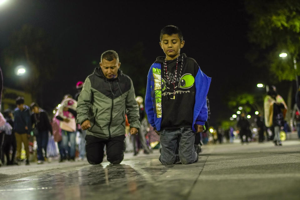 Pilgrims walk on their knees in an act of devotion as they arrive to the Basilica of Guadalupe in Mexico City, early Monday, Dec. 12, 2022. Devotees of the Virgin of Guadalupe make the pilgrimage for her Dec. 12 feast day, the anniversary of one of several apparitions of the Virgin Mary witnessed by an Indigenous Mexican man named Juan Diego in 1531. (AP Photo/Aurea Del Rosario)