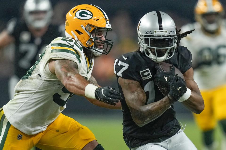 Las Vegas Raiders' Davante Adams catches a pass in front of Green Bay Packers' Isaiah McDuffie during the second half of an NFL football game Monday, Oct. 9, 2023, in Las Vegas. (AP Photo/John Locher)