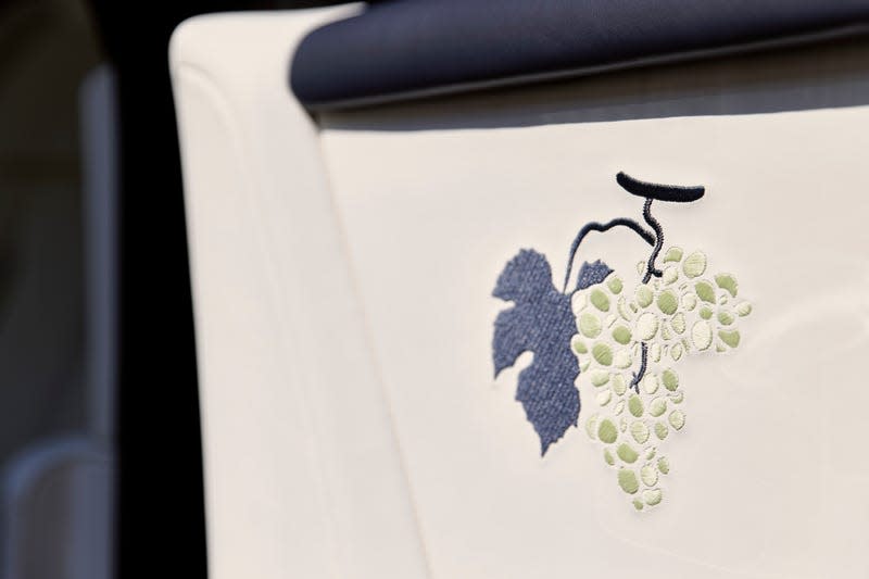 Detail view of embroidered grapes on a Rolls-Royce door