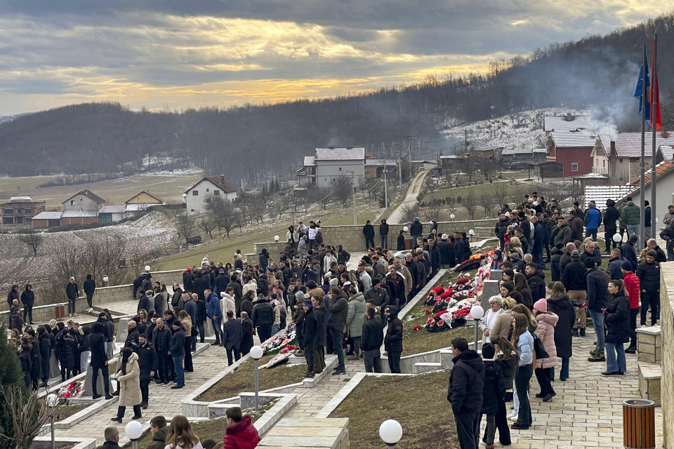 People walk in a cemetery during a memorial event for Kosovars killed in 1999 by Serb forces in Recak, Kosovo, Monday, Jan. 15, 2024. Hundreds of Kosovars have gathered in a southern village to commemorate the 25th anniversary of the mass killing of 45 ethnic Albanians by Serb forces which was a decisive moment to spark international anger and prompt a 78-day U.S. and NATO air campaign to end Kosovo's 1998-99 war.(AP Photo/Zenel Zhinipotoku)