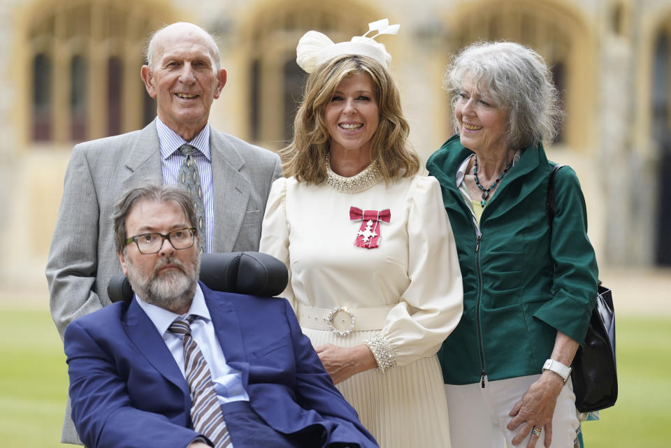 Kate Garraway pictured with Draper, and her parents Gordon and Marilyn Garraway after receiving an MBE. (Getty Images)