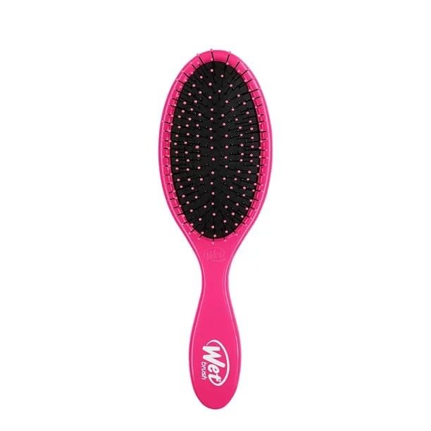 Pink hair brush against a white background