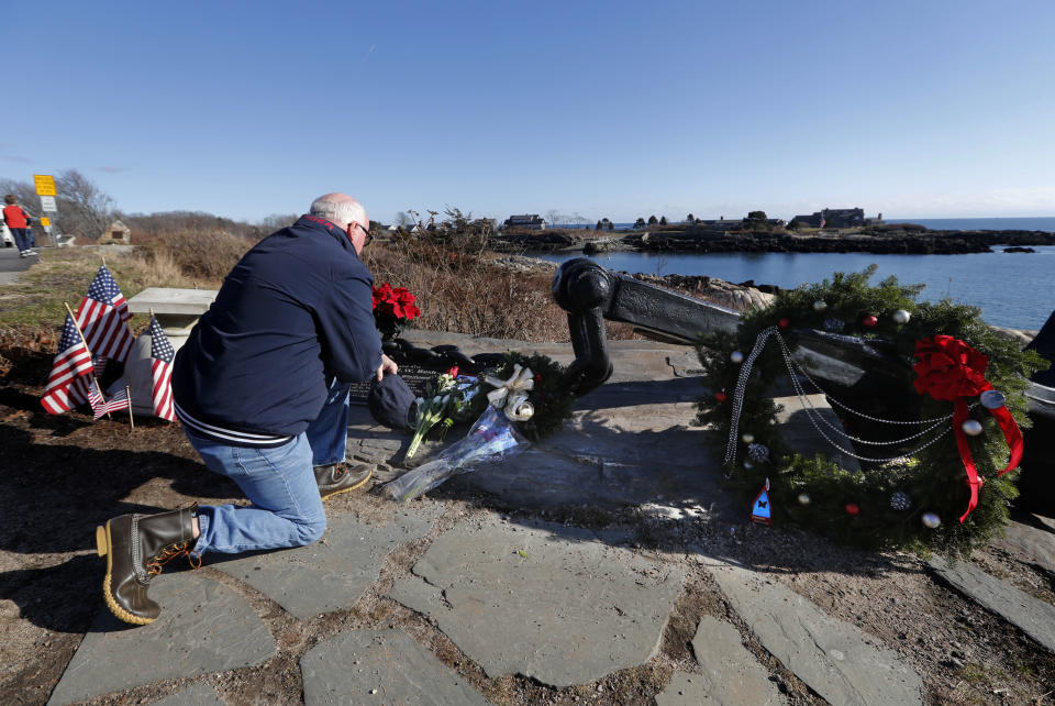 A man pays his respects to former President George H. W. Bush at a makeshift memorial across from Walker's Point, the Bush's summer home, Saturday, Dec. 1, 2018, in Kennebunkport, Maine. Bush died at the age of 94 on Friday, about eight months after the death of his wife, Barbara Bush. (AP Photo/Robert F. Bukaty)