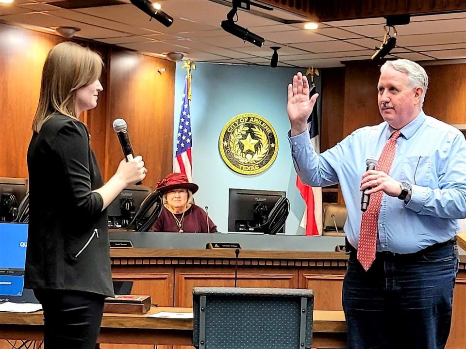 Abilene City Secretary Shawna Atkinson swears in Place 1 councilman Shane Price in 2021. Price originally joined the council in 2009.