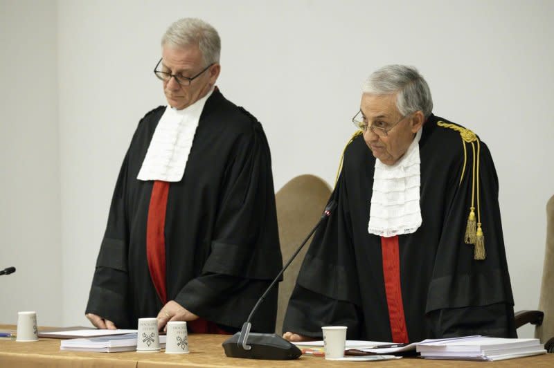 Vatican City State Court President Giuseppe Pignatone (R) and University of Rome law professor Venerando Marano (L) announce the verdict in the trial of Cardinal Angelo Becciu and nine others for financial wrongdoing at The Vatican on Saturday. Photo by Vatican Media/EPA-EFE