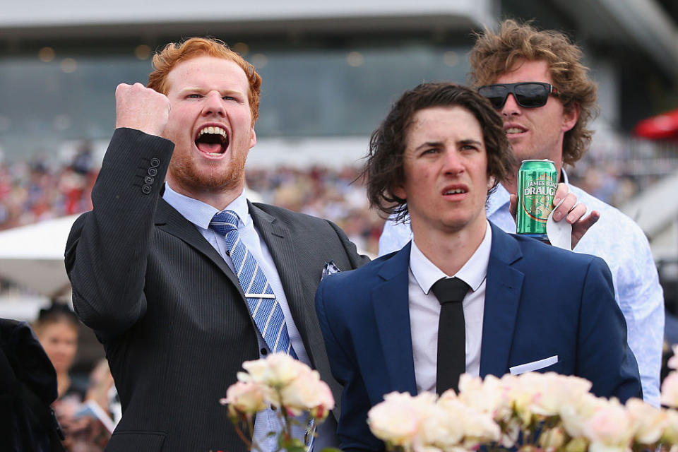 A punter celebrates a win while his mate seems less pleased on Melbourne Cup Day at Flemington in 2016. Source: Getty Images.