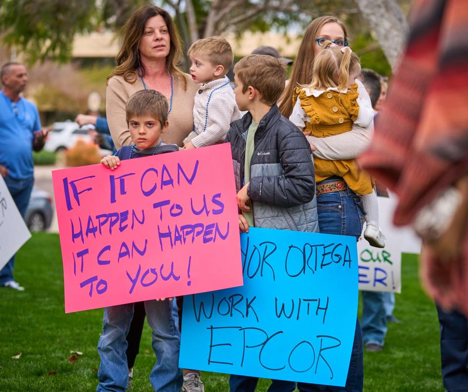 James Reim, 8, holds a sign as he, his family and other residents of the Rio Verde Foothills protest after Scottsdale cut off their access to water at the start of 2023, at the Scottsdale Civic Center on Tuesday, Jan. 10, 2023.