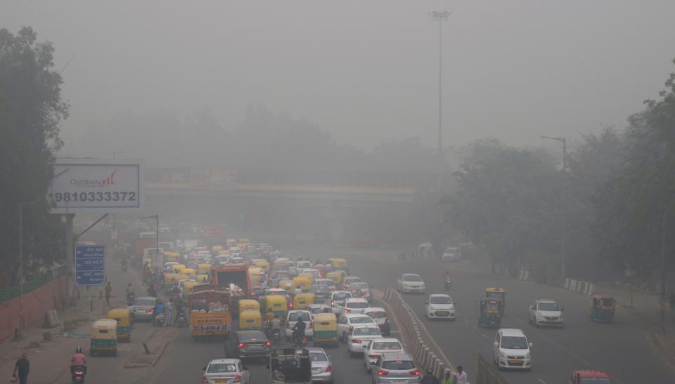 Vehicles wait for a signal at a crossing as New Delhi is enveloped in smog Nov. 3.