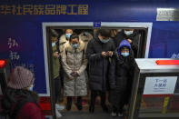 Commuters wearing face masks to help curb the spread of the coronavirus crowd inside a subway train during a rush hour in Beijing, Tuesday, Jan. 5, 2021. Wary of another wave of infections, China is urging tens of millions of migrant workers to stay put during next month's Lunar New Year holiday, usually the world's largest annual human migration. (AP Photo/Andy Wong)