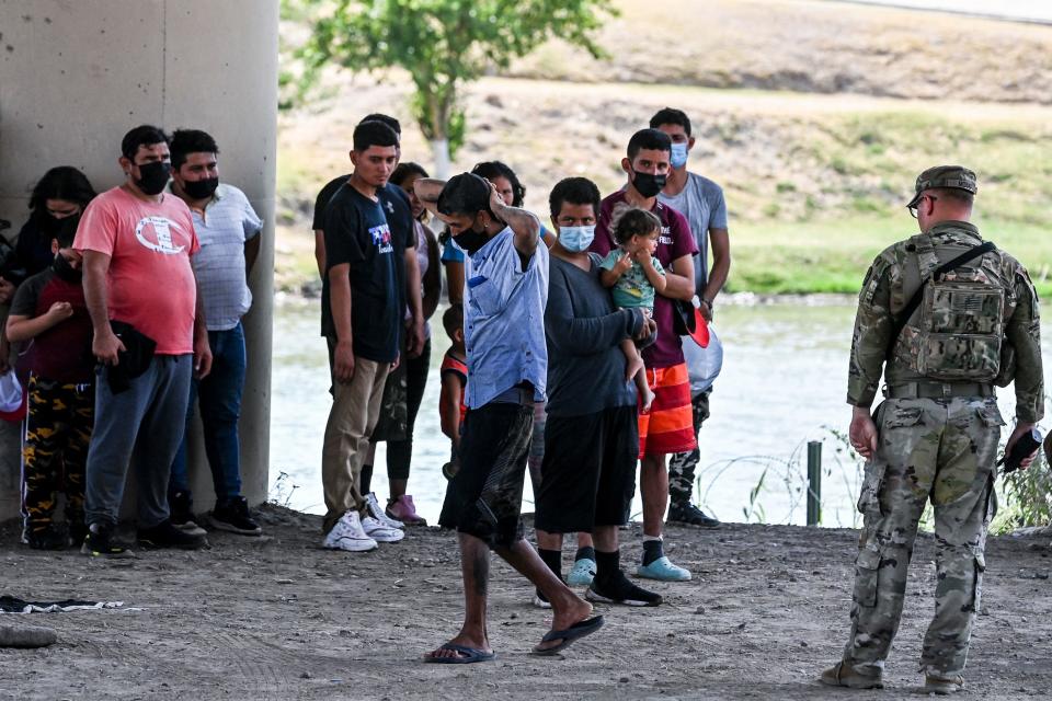 Migrants are apprehended by US Border Patrol and National Guard troops in Eagle Pass, Texas, near the border with Mexico on June 30, 2022.  / Credit: CHANDAN KHANNA/AFP via Getty Images