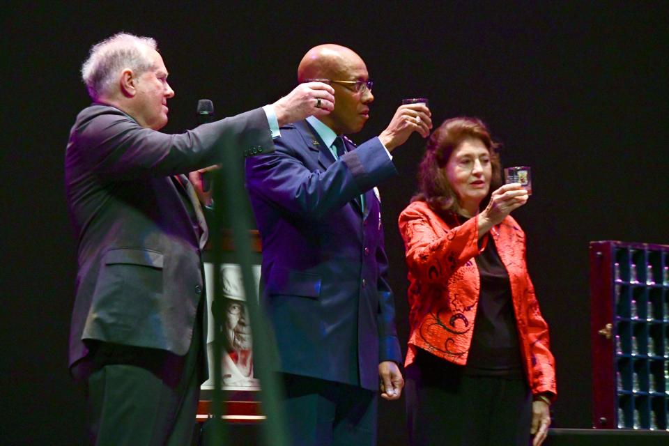 United States Air Force Secretary Frank Kendall, Air Force Chief of Staff Gen. Charles Brown and Cindy Cole Chal, daughter of Lt. Col. Richard "Dick" Cole, make a final toast Monday to Cole and the rest of the Doolittle Raiders who passed before him during a ceremony at Northwest Florida State College's Mattie Kelly Arts Center.