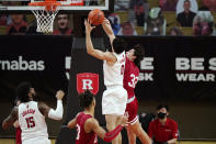 Indiana guard Trey Galloway (32) grabs the arm of Rutgers guard Geo Baker (0) as Rutgers center Myles Johnson (15) watches during the second half of an NCAA college basketball game, Wednesday, Feb. 24, 2021, in Piscataway, N.J. Rutgers defeated Indiana 74-63. (AP Photo/Kathy Willens)