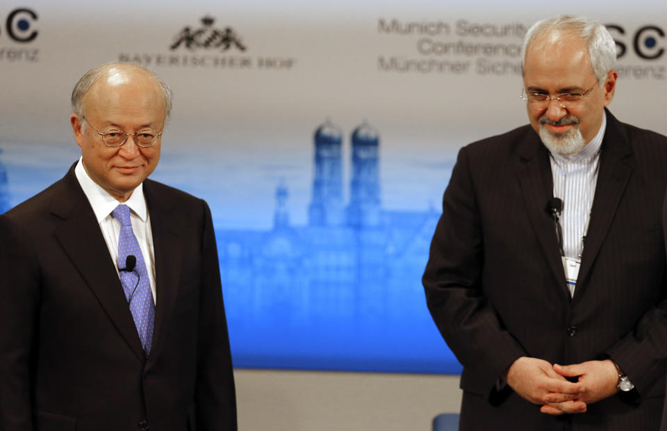 Iran's Foreign Minister Mohammad Javad Zarif, right, waits next to Director General of the International Atomic Energy Agency, IAEA, Yukiya Amano, for the start of a panel discussion at the 50th Security Conference on security policy in Munich, Germany, Sunday, Feb. 2, 2014. (AP Photo/Frank Augstein)