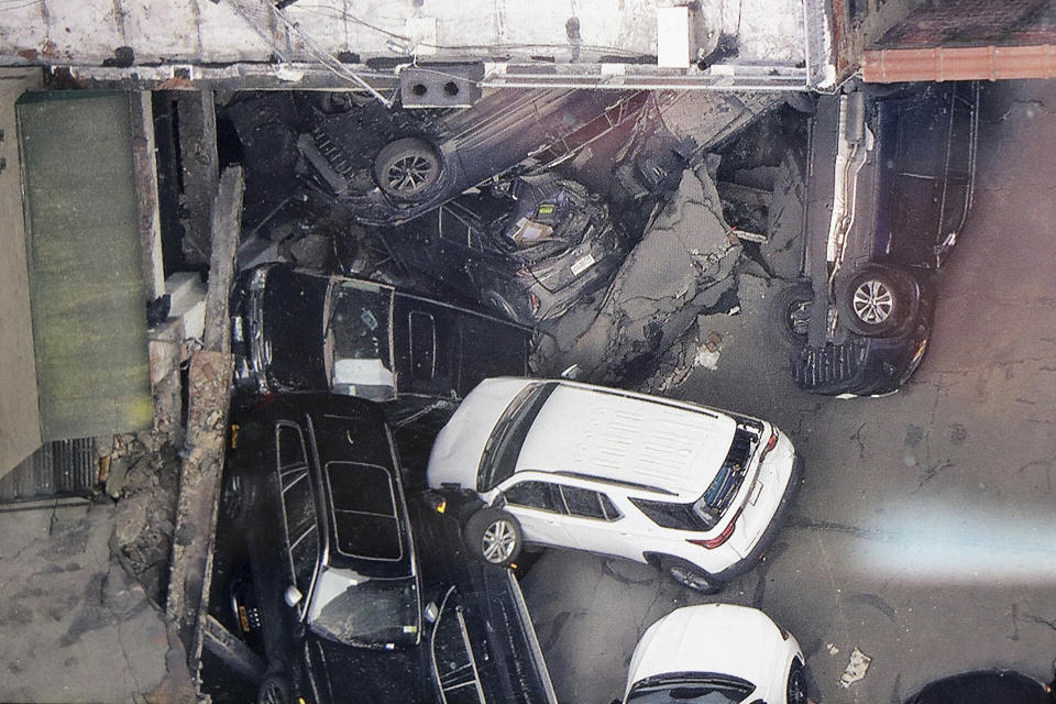 Cars are seen at the partial collapse of a parking garage in the Financial District of New York, Wednesday, April 19, 2023, in New York. The parking garage collapsed Tuesday in lower Manhattan’s Financial District, killing one worker, injuring five and crushing cars as concrete floors fell on top of each other like a stack of pancakes, officials said. (Tom Kaminski/WCBS 880 News via AP)