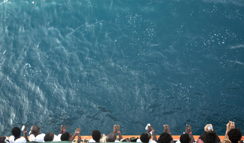 FILE - In this Friday, Sept. 1, 2017 file photo, African migrants who were rescued from the Mediterranean Sea north of the Libyan coast, look out from the deck as the Aquarius vessel of SOS Mediterranee and MSF (Doctors Without Borders) NGOs, approaches the port of Pozzallo on Sicily, Italy. Migrants trying to reach Europe face routine rape and sexual torture throughout their journey _ and especially in Libya _ with men facing abuse nearly as routinely as women, according to a study based on dozens of interviews with aid workers and migrants. (AP Photo/Darko Bandic, File)