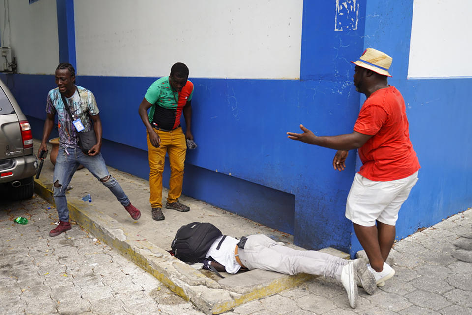 FILE - Haitian journalist Romelson Vilsaint, who was fatally wounded, lies face down in the parking lot of a police station in Port-au-Prince, Haiti, Sunday, Oct. 30, 2022. According to a report released Tuesday, Jan. 24, 2023, by the New York-based Committee to Protect Journalists, killings of journalists around the world jumped by 50% in 2022 compared to the previous year, driven largely by murders of reporters in the three deadliest countries: Ukraine, Mexico and Haiti. (AP Photo, FILE)