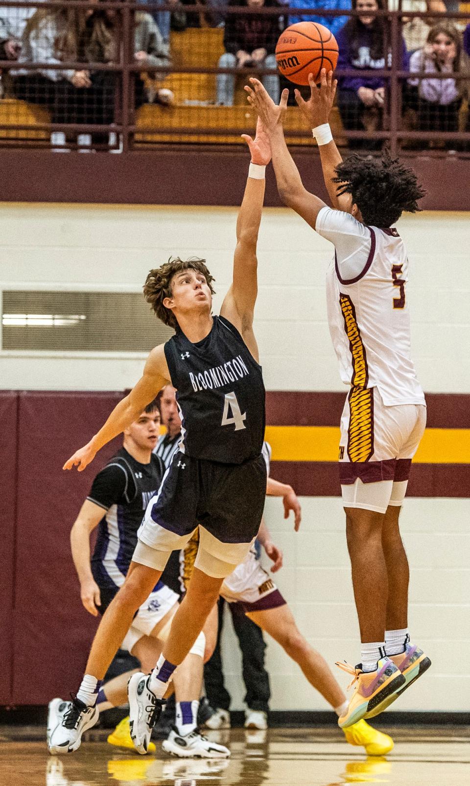 North's Jalen Williams (5) hits the game winning shot over South's Alex Shaevitz (4) during overtime of the Bloomington North versus Bloomington South boys basketball game at Bloomington High School North on Friday, Jan. 5, 2024. North won the game 56-53.