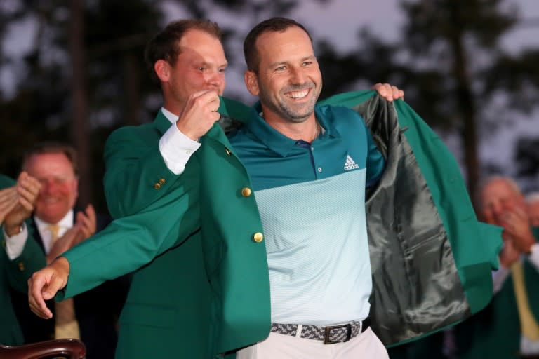 Danny Willett of England presents Sergio Garcia of Spain with the green jacket after Garcia won in a playoff during the final round of the 2017 Masters tournament, at Augusta National Golf Club in Georgia, on April 9