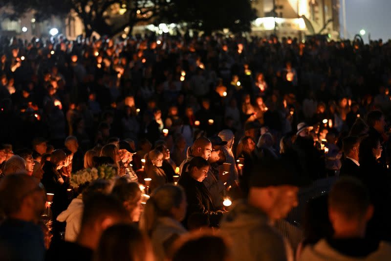 People gather for a candlelight vigil on Bondi Beach to pay respects to the victims of a fatal stabbing attack at a shopping centre in Sydney