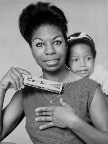 <p>Michael Ochs Archives/Getty</p> Nina Simone poses with daughter Lisa for a Crest toothpaste advertisement circa 1964.