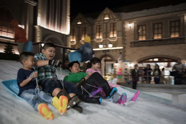 Children enjoy sledding at Snow Town in Bangkok