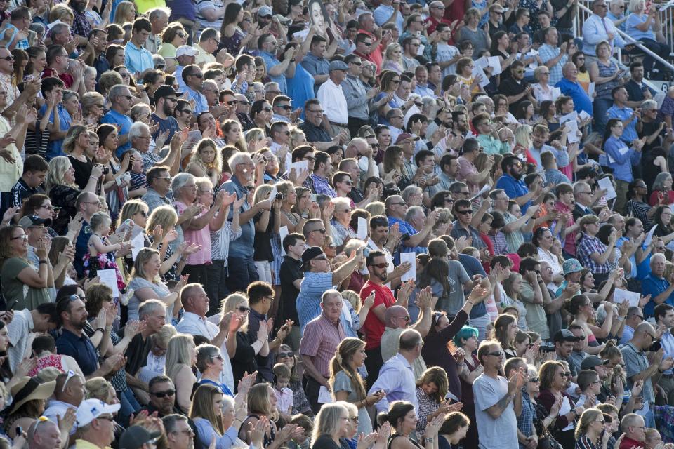 The crowd stands on their feet to applaud the graduates during the Reitz High School class of 2019 graduation at the Reitz Bowl Wednesday, May 22, 2019.