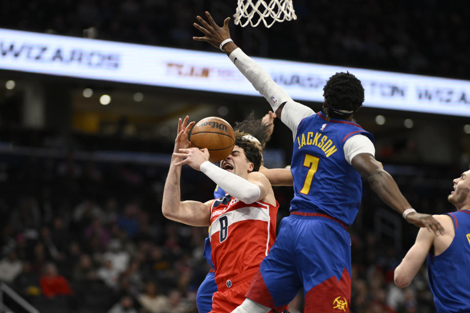 Washington Wizards forward Deni Avdija (8) loses the ball against Denver Nuggets guard Reggie Jackson (7) during the first half of an NBA basketball game, Sunday, Jan. 21, 2024, in Washington. (AP Photo/Nick Wass)