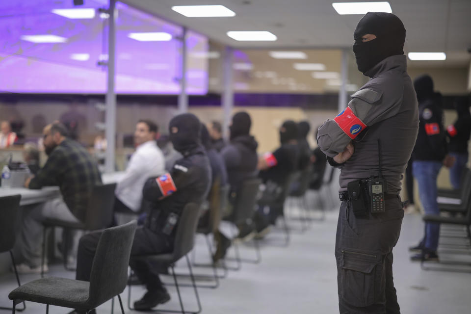 Defendants sit in a specially designed glass box in the courtroom during the start of the Brussels terrorist attack trial verdict in the Justitia building in Brussels, Tuesday, July 25, 2023. A jury is expected to render its verdict Tuesday over Belgium's deadliest peacetime attack. The suicide bombings at the Brussels airport and a busy subway station in 2016 killed 32 people in a wave of attacks in Europe claimed by the Islamic State group. (Olivier Matthys, Pool Photo via AP)