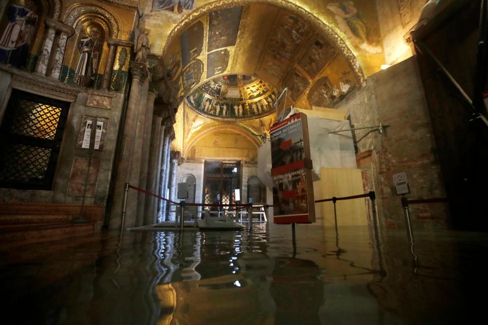 The entrance to St. Mark's Basilica is flooded on the occasion of a high tide, in Venice, Italy, Tuesday, Nov. 12, 2019.