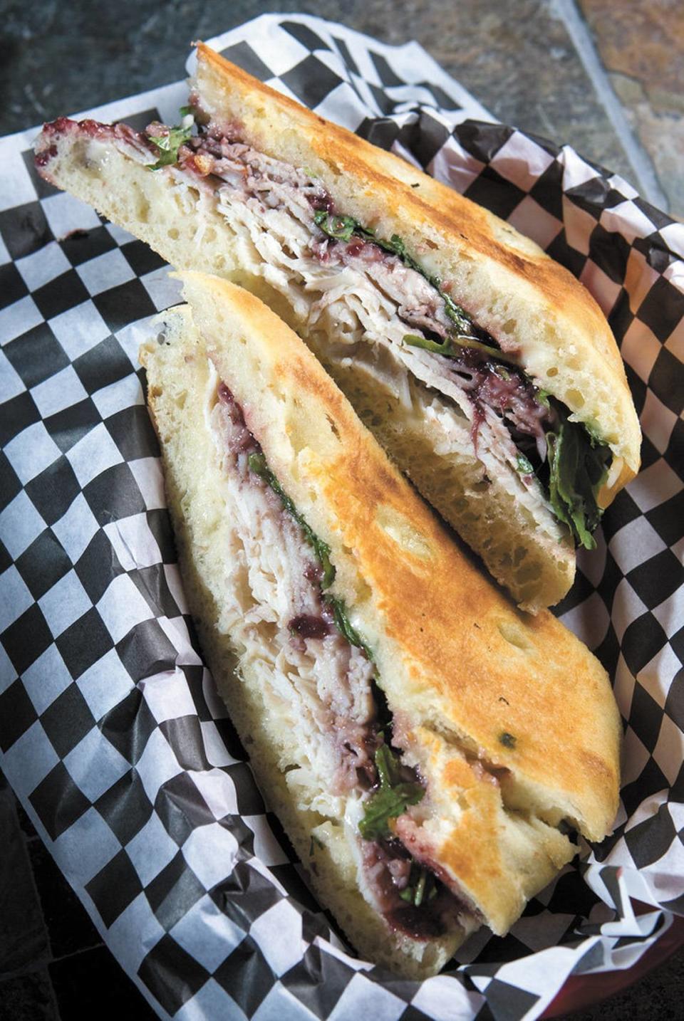 The Pomegranate Chipotle Turkey panino features sharp cheddar, pomegranate chipotle sauce and arugula on focaccia.