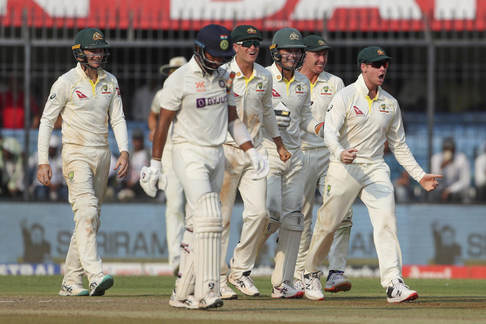 Australia's captain Steve Smith, right, celebrates with teammate the dismissal of India's Cheteshwar Pujara, second left, during the second day of third cricket test match between India and Australia in Indore, India, Thursday, March 2, 2023. (AP Photo/Surjeet Yadav)