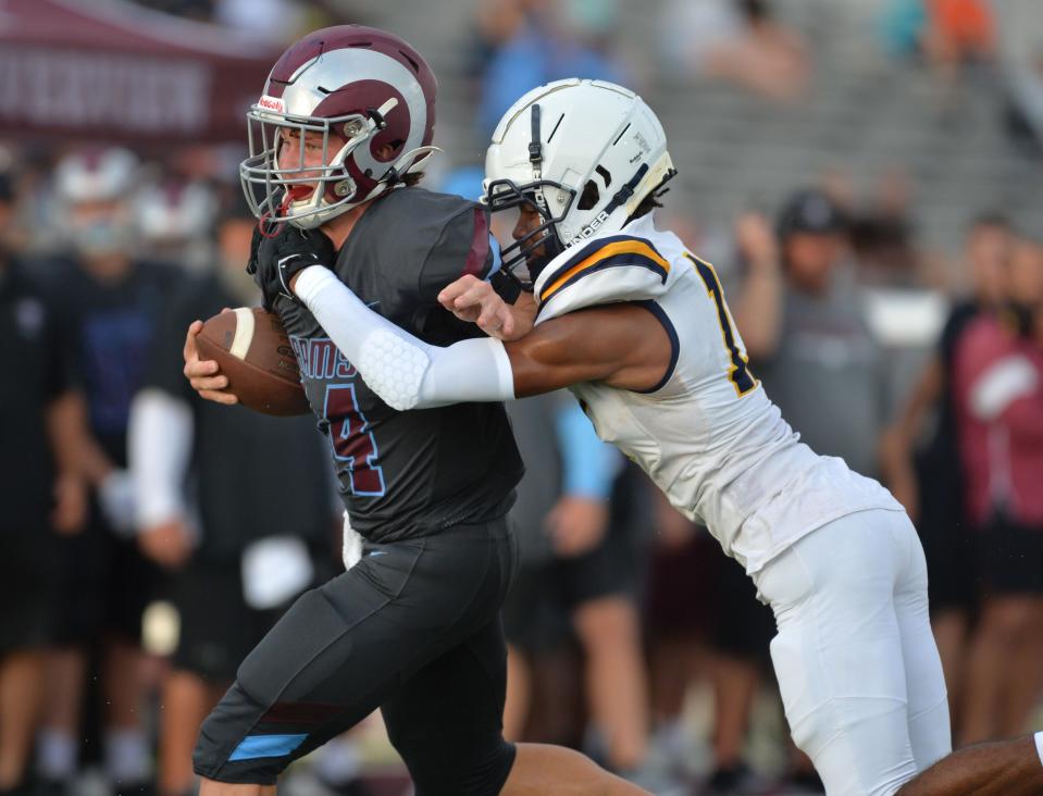 Riverview quarterback Anthony Miller (#14) is tackled by Lehigh defender Sean Battle (#11). Riverview High School hosted Lehigh High School in a spring football game on Friday evening, May 26, 2023. 