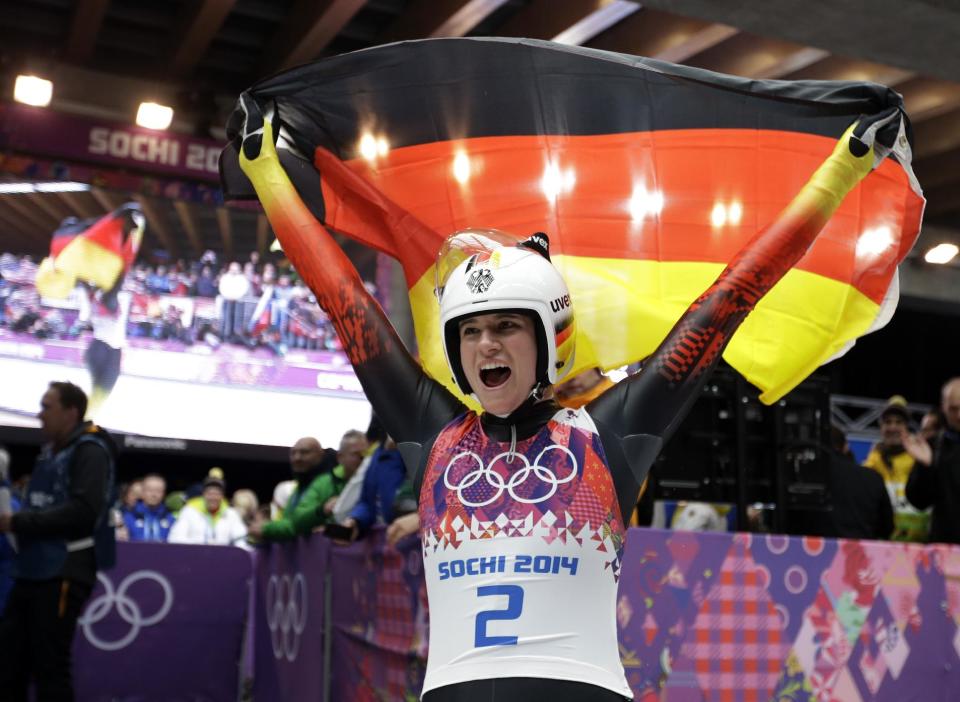 Natalie Geisenberger of Germany waves the flag fter finishing her final run to win the gold medal during the women's singles luge competition at the 2014 Winter Olympics, Tuesday, Feb. 11, 2014, in Krasnaya Polyana, Russia. (AP Photo/Natacha Pisarenko)