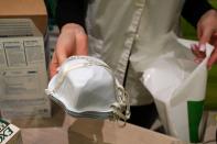 A pharmacy worker sells N95 face masks in advance of the potential coronavirus outbreak in the Manhattan borough of New York City