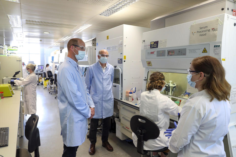 EMBARGOED: not for publication before 2200 BST Wednesday June 24, 2020. The Duke of Cambridge wears a mask as he meets scientists, including Christina Dold (right), during a visit to the manufacturing laboratory where a vaccine against COVID-19 has been produced at the Oxford Vaccine Group's facility at the Churchill Hospital in Oxford.