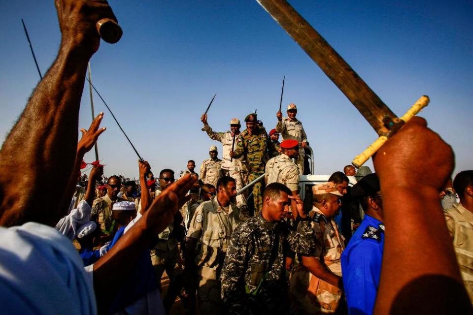 RSF commander Mohamed Hamdan Dagalo, known as Hemedti, waves a baton to rally supporters in the village of Qarri near Khartoum in Sudan.