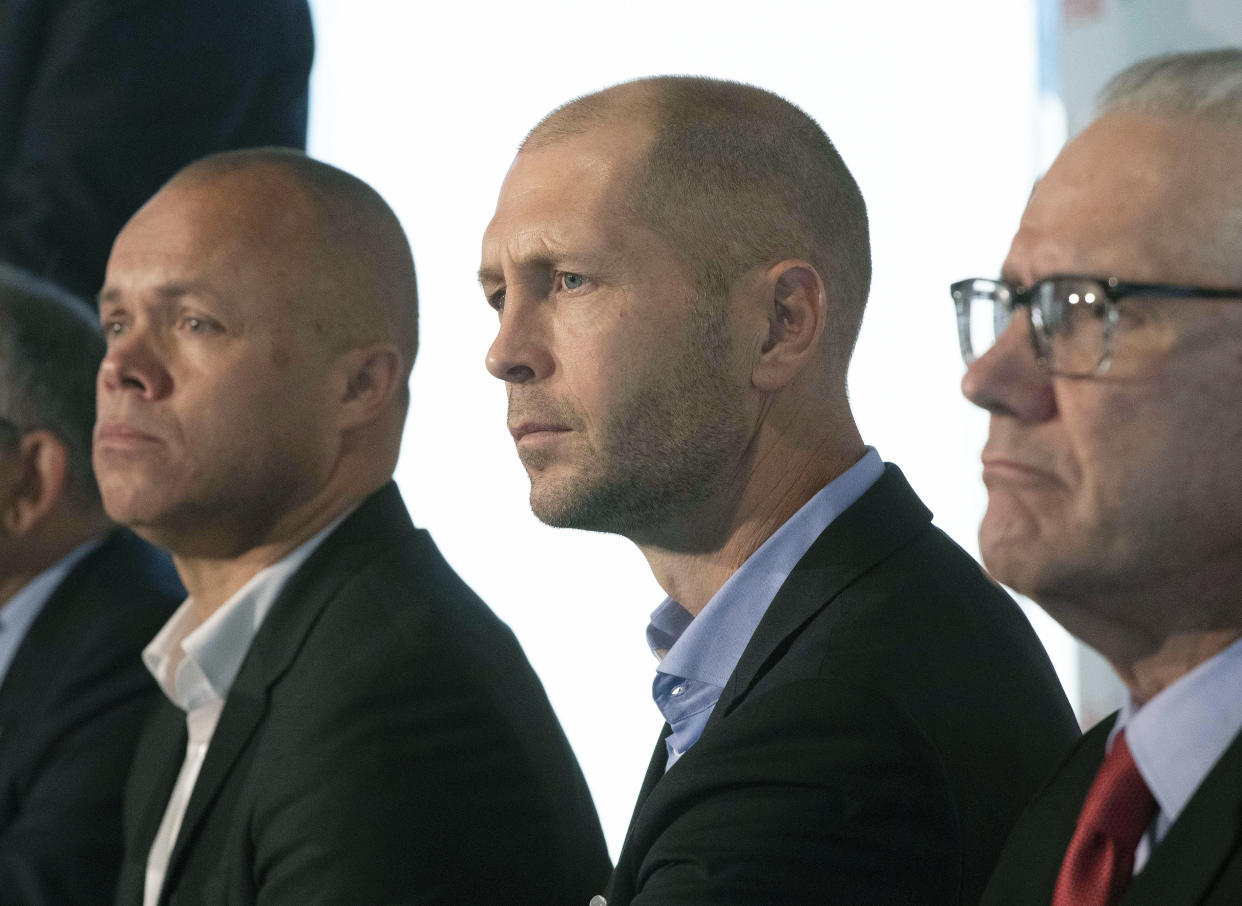 With Earnie Stewart (L) exiting his position as U.S. Soccer sporting director, it seems less likely that his hand-picked coach, Gregg Berhalter (C), returns. (AP Photo/Mark Lennihan)