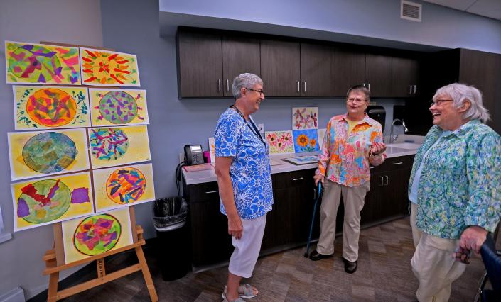 Retired nuns, from left, Sister Martha Waligora, Sister Susan Ann Adrians and Sister Karen Walther, gather in the fine arts studio at Trinity Woods, an intergenerational housing facility on the campus of Mount Mary University.