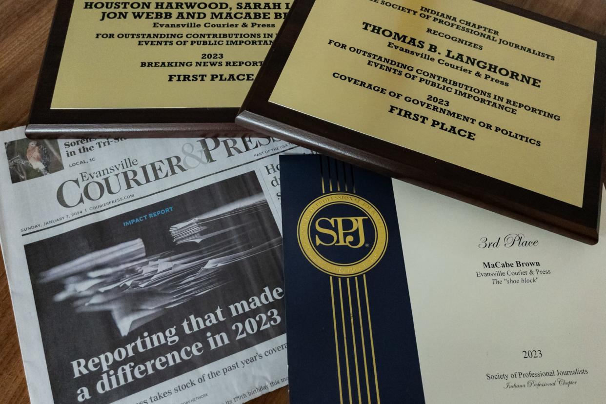 A Courier & Press newspaper on display with several awards the Indiana chapter of the Society of Professional Journalists presented to Courier & Press reporters on Friday, April 26, 2024.