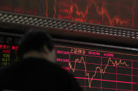 An investor monitors shares prices at a quiet brokerage house in Beijing, Wednesday, March 27, 2019. Shares were mixed in Asia early Wednesday after U.S. stocks finished broadly higher on Wall Street, erasing modest losses from a day earlier. (AP Photo/Andy Wong)