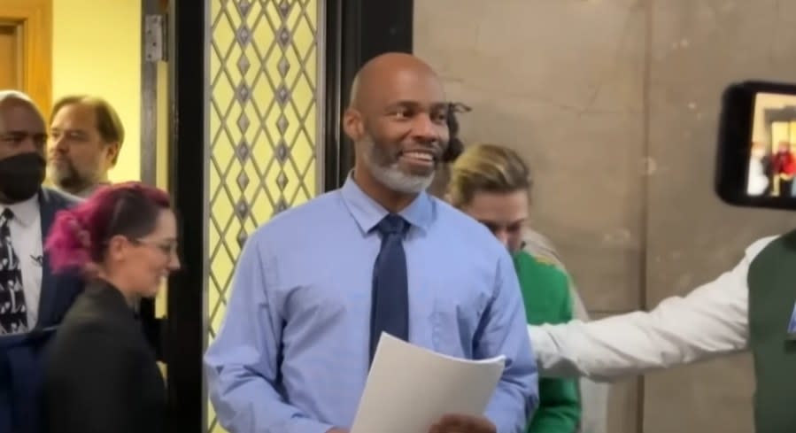 Lamar Johnson smiling in front of the press as he is finally walking out a free and exonerated man