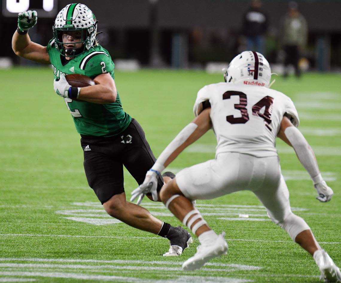 Southlake Carroll’s Owen Allen, left, cuts away from Midland Legacy’s Mario Serrano as he races up the field for a first down near the goal line in the fourth quarter of their Class 6A Division 1 Area football game Saturday, November 20, 2021 at Globe Life Field in Arlington, Texas. Carroll went on to win 42-7.  Special/Bob Haynes