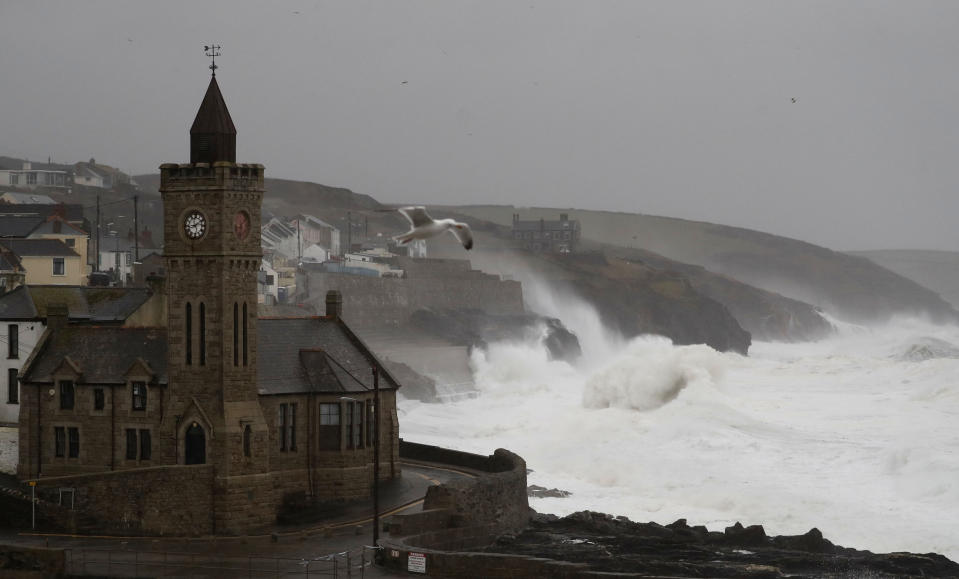 Powerful waves break on the shoreline around the small port of Porthleven, south west England, Sunday, Feb. 16, 2020. Storm Dennis roared across Britain on Sunday, lashing towns and cities with high winds and dumping so much rain that authorities urged residents to protect themselves from "life-threatening floods" in Wales and Scotland. (AP Photo/Alastair Grant)