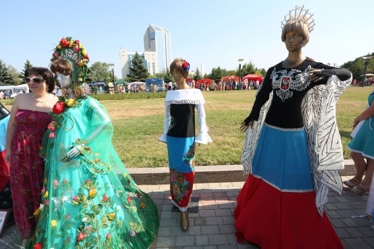 The blue and red flag of the self-proclaimed Donetsk People's Republic (DPR) and the two-headed eagle featured prominently in designs showcased at an open-air fashion show in the rebel capital