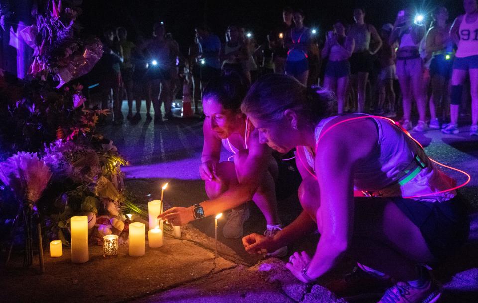 Runners stop at the location where Eliza Fletcher was reportedly kidnapped to pay their respects during the Let's Finish Liza's Run event on Friday, Sept. 9, 2022, along Central Avenue in Memphis. “Our goal is to stand up for the women in the Mid-South and emphasize that women should be able to safely run any time of day,” the Facebook event said. 